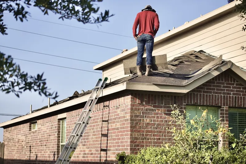 Professional roofer working on a residential roof in Laporte